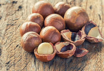 Group of macadamia in shell on wood background