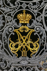Ornate wrought iron gate of Winter Palace Hermitage in Saint Petersburg, Russia with imperial crown...