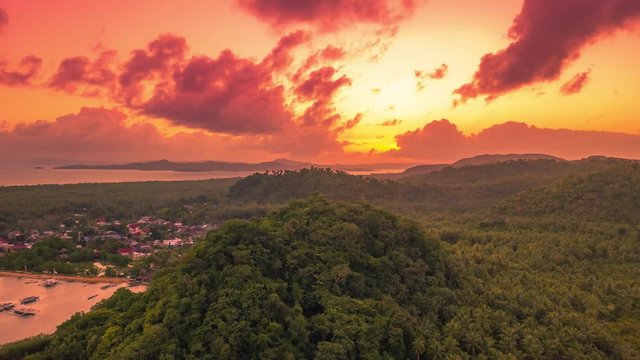 Sunset overlooking the mountain and mangrove jungle on the Siargao island, Philippines. Aerial Drone Timelapse 4K