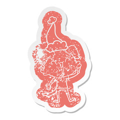 happy little dog cartoon distressed sticker of a wearing santa hat