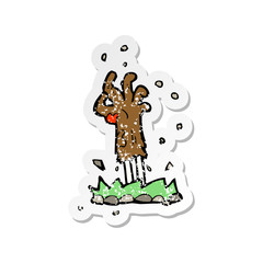 retro distressed sticker of a cartoon zombie hand rising from ground