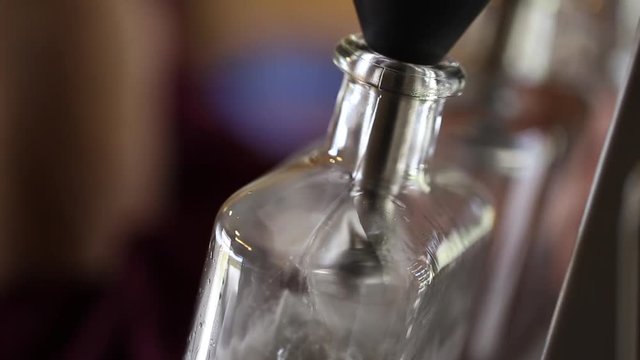 Close up footage of gin being bottled in a craft gin distillery