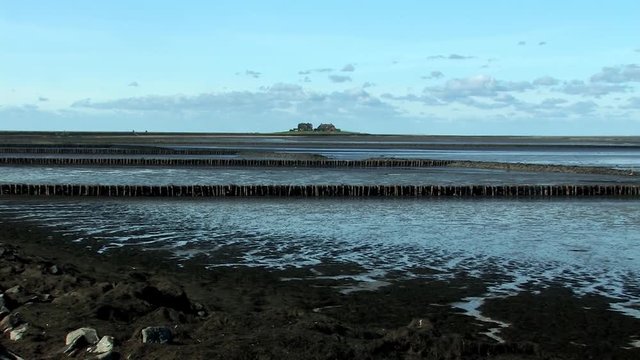 Low tide on Holm Hooge at the North Sea with land reclamation (breakwater), Germany.