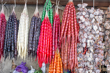 Georgia, local market. Sale of national sweets from grapes and nuts - "Churchkhela", dried fruit.