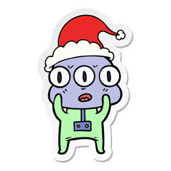 sticker cartoon of a three eyed alien wearing santa hat