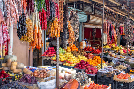 Georgia, the local bazaar. Sale of national sweets from grapes and nuts - "Churchkhela", fresh and dried fruits and vegetables