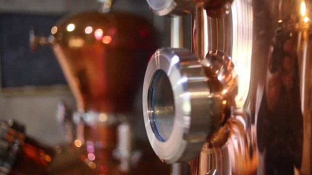 Close up footage of gauges, copper stills and gin being distilled in this step by step process of how to make gin