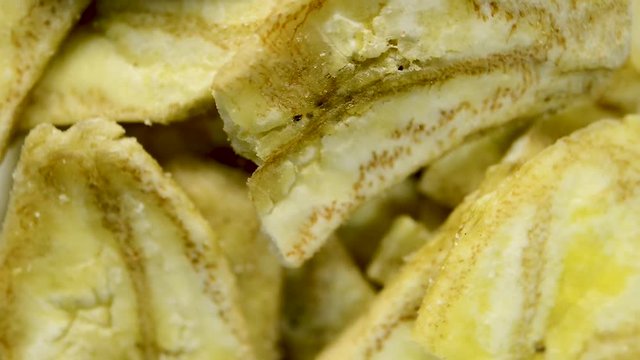 Close up of banana chips rotating. Flat plane. Top view