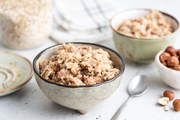 Oatmeal porridge with linseeds in bowl. Healthy vegan vegetarian breakfast rich in fiber and omega-3 amino acids