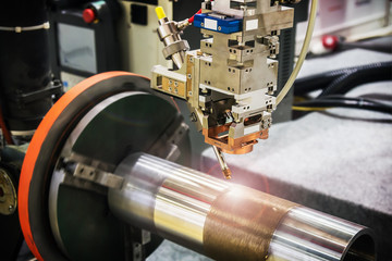 laser processes the metal part in the laboratory