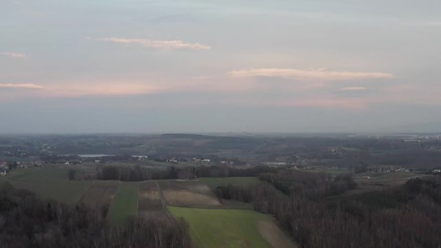 Drone shot of fields and coal mine in the distance