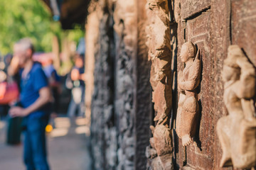 Archaeological, Close Up of carved art figures on old wood carvings on the wall temple at Shwe Nan...