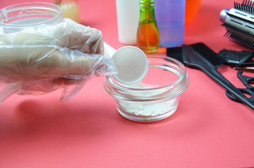Barber shop set with hair dye, hairbrush, scissors, spray and brush on pink red background