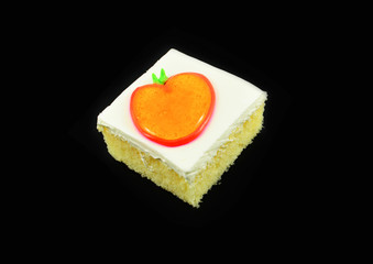 Obraz na płótnie Canvas Piece slice cake with cream and orange jelly topping isolated on black background
