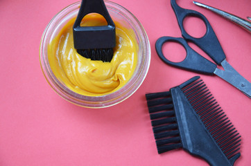 Barber shop set with hair dye, hairbrush, scissors, spray and brush on pink red background