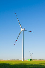 Windmill in a green field.