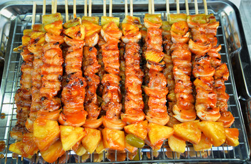 Barbecue grilled assorted sweet savory delicious with meat pork vegetables and fruit on grill BBQ.