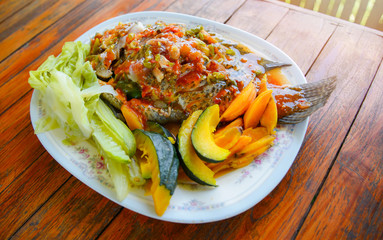 Cooking food tilapia fish steamed herb with chilli sauce spicy