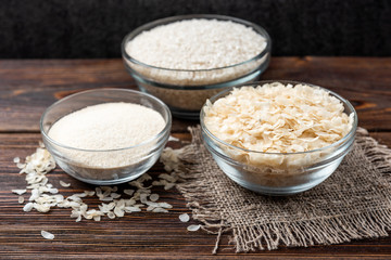 Rice on dark wooden background.