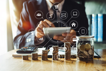 businessman accountant working on desk using mobile phone and calculator to calculate budget concept finance and accounting in morning light