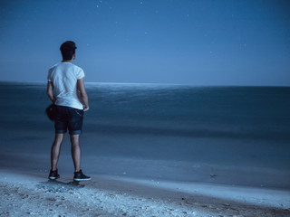 lonely man on the night beach