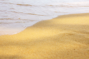 Fototapeta na wymiar Water waves on sand beach.