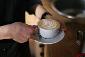 cup of coffee rosetta pouring coffeeshop barista