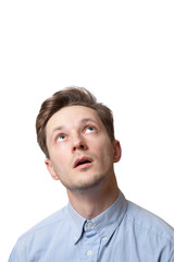 Obraz premium handsome brunette male with pensive expression, dressed in fashionable shirt, tries to remember something, isolated over white background with copy space for your promotional text
