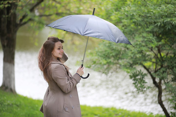 Young girl in a coat in a spring park