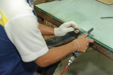 Worker using handy air belt sander