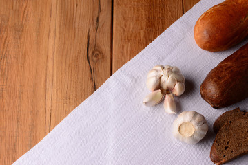 Fresh bread and garlic on table