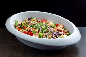 Salad with herring, greens, boiled eggs and pepper.