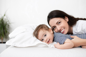 Fototapeta na wymiar mother and baby boy on bed
