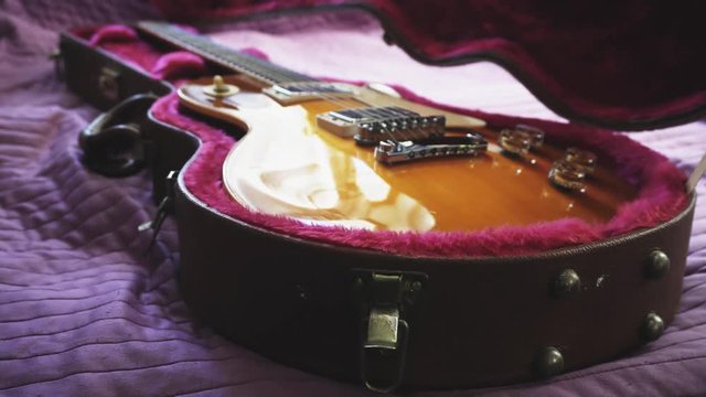 Man put a guitar into a case