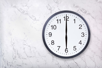 Wall clock show six o'clock on white marble texture. Office clock show 6pm or 6am on marble...