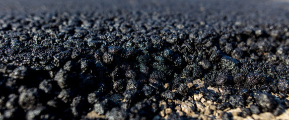 Stones on the edge of the asphalt road
