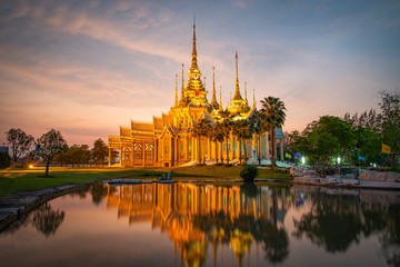 Fototapeta na wymiar Beautiful temple thailand dramatic colorful sky twilight sunset shadow on water reflection