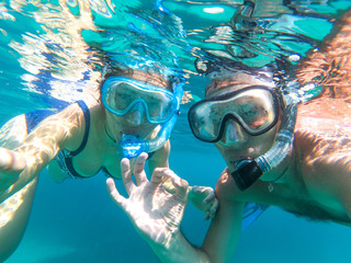 Underwater view of snorkeling couple in the sea
