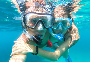 Underwater view of snorkeling couple in the sea