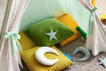 Hovel with soft pillows in kid room