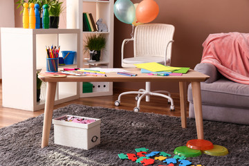 Wooden table in stylish interior of kid room