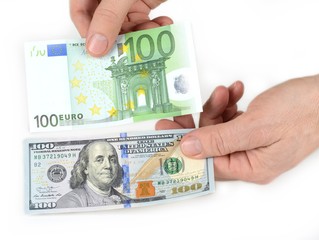 Dollar and euro in the hand. Comparison