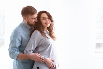 Happy pregnant couple at home