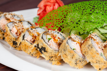 Japanese national popular cuisine. Sushi, rice and fish. Tasty, beautifully served food in a restaurant, cafe, with elements of the original design.