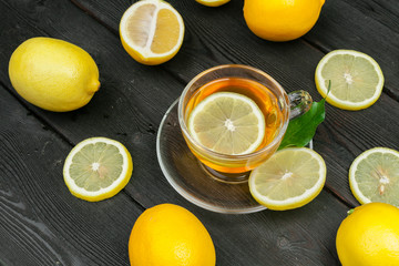 lemon tea with lemon and lime on wooden table