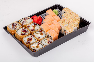 Japanese national popular cuisine. Sushi, rice and fish. Tasty, beautifully served food in a restaurant, cafe, with elements of the original design.