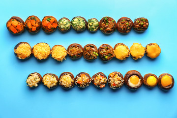 Tasty stuffed mushrooms on color background