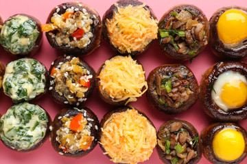 Tasty stuffed mushrooms on color background