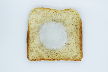Monosodium glutamate (MSG) on slice breads isolated on white background.