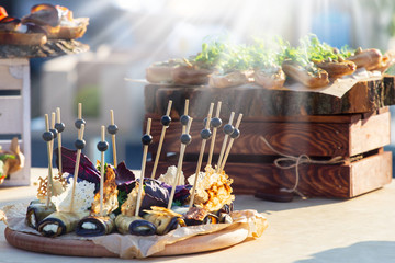 Beautifully decorated catering banquet table with different food snacks and appetizers with...